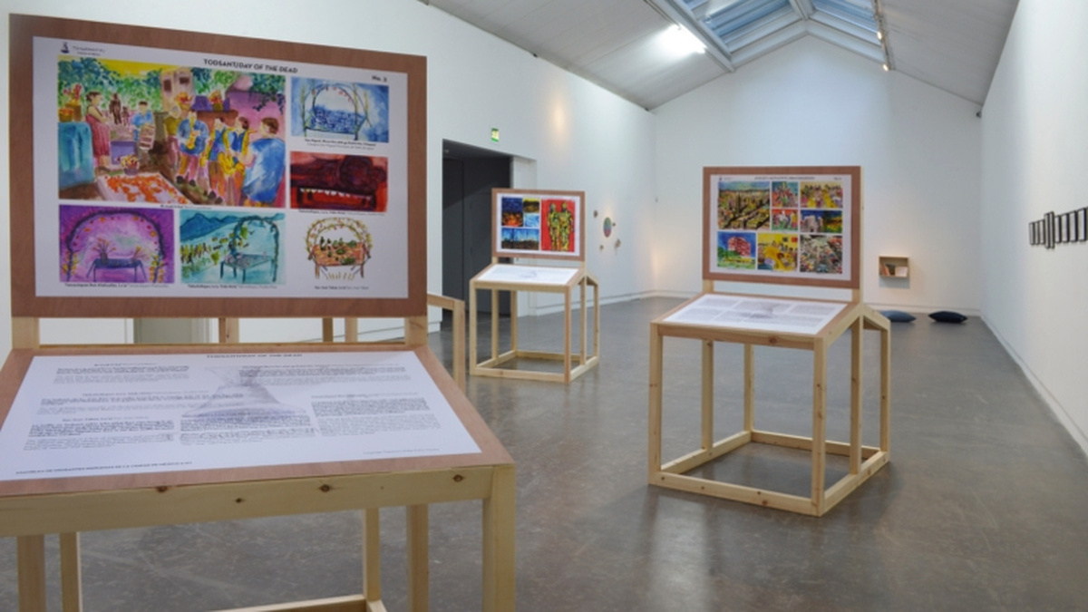 A gallery space with three wooden display boards.