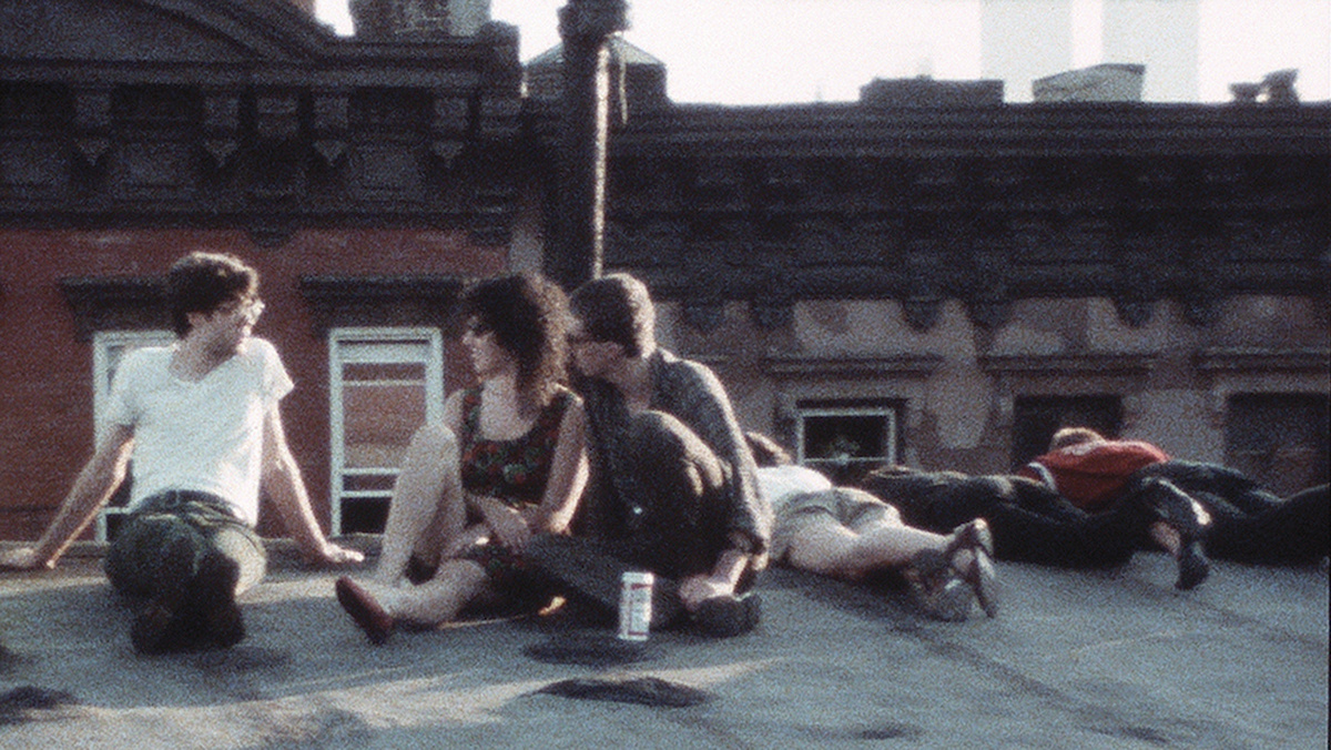 A grainy image shows a group of young adults on the roof of a residential New York building.