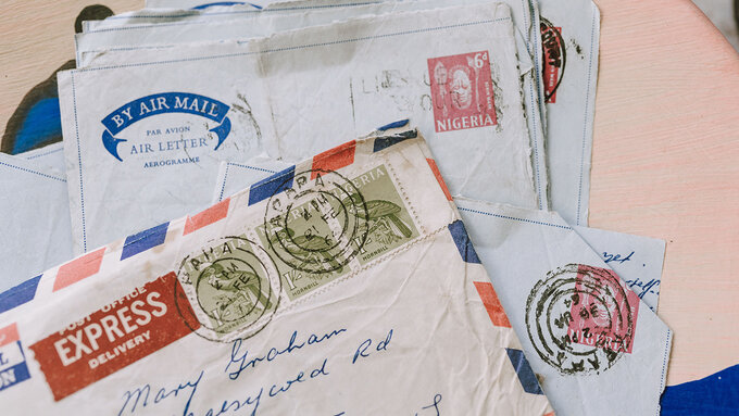 A pile of old airmail letters whose envelopes have been opened