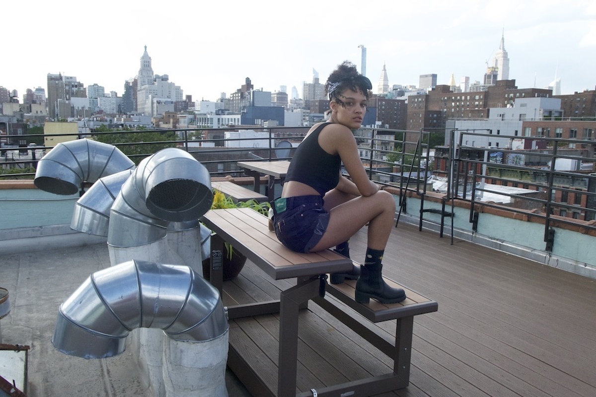 A person sits on a New York rooftop.