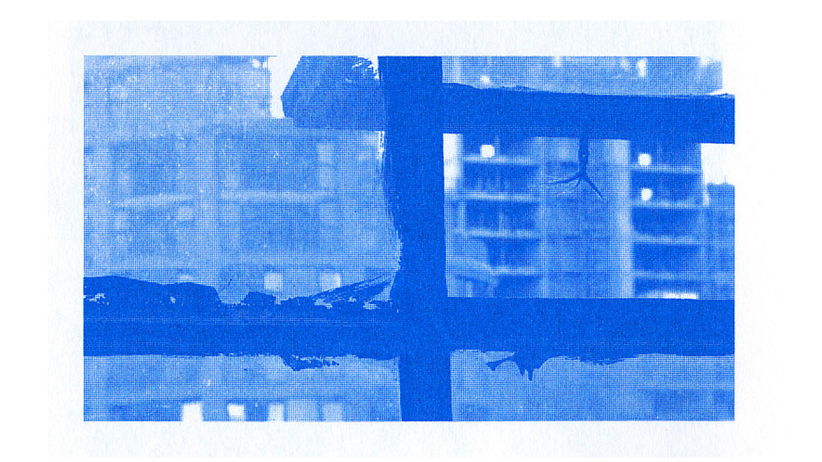 A blue photo of an urban landscape through a half open window