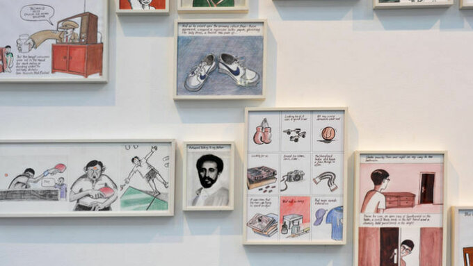 a gallery view of framed comic pages on a wall