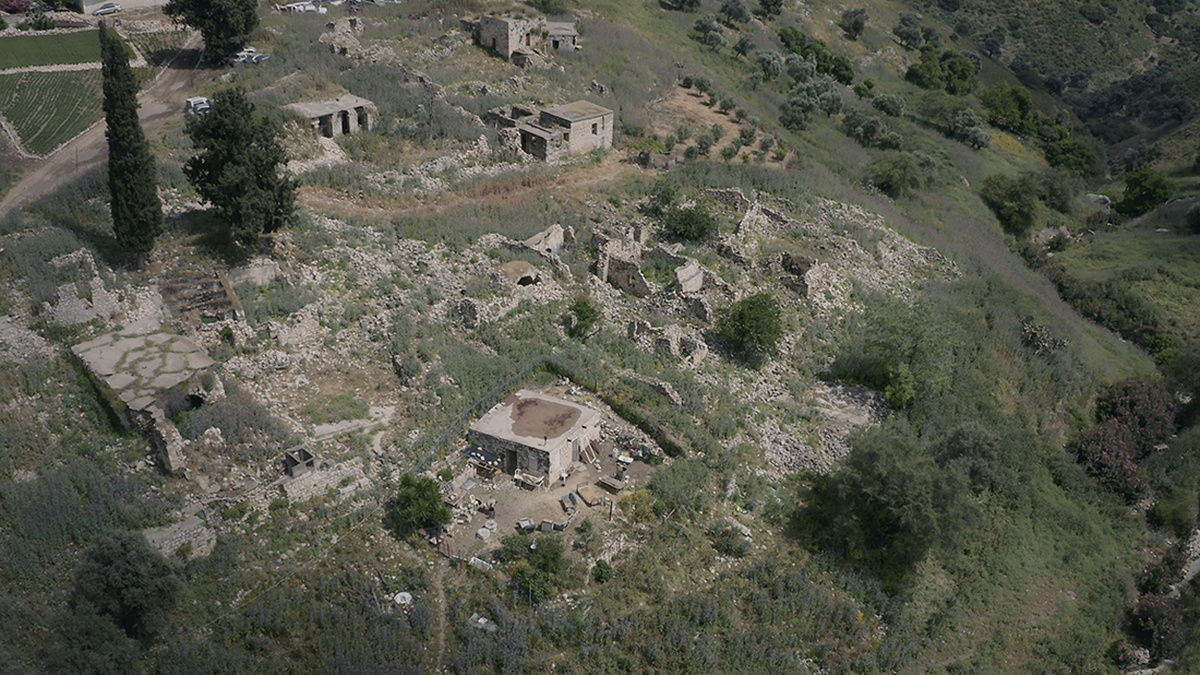 A still from 'Foragers'. A bird's eye view shot of ruins in the countryside.