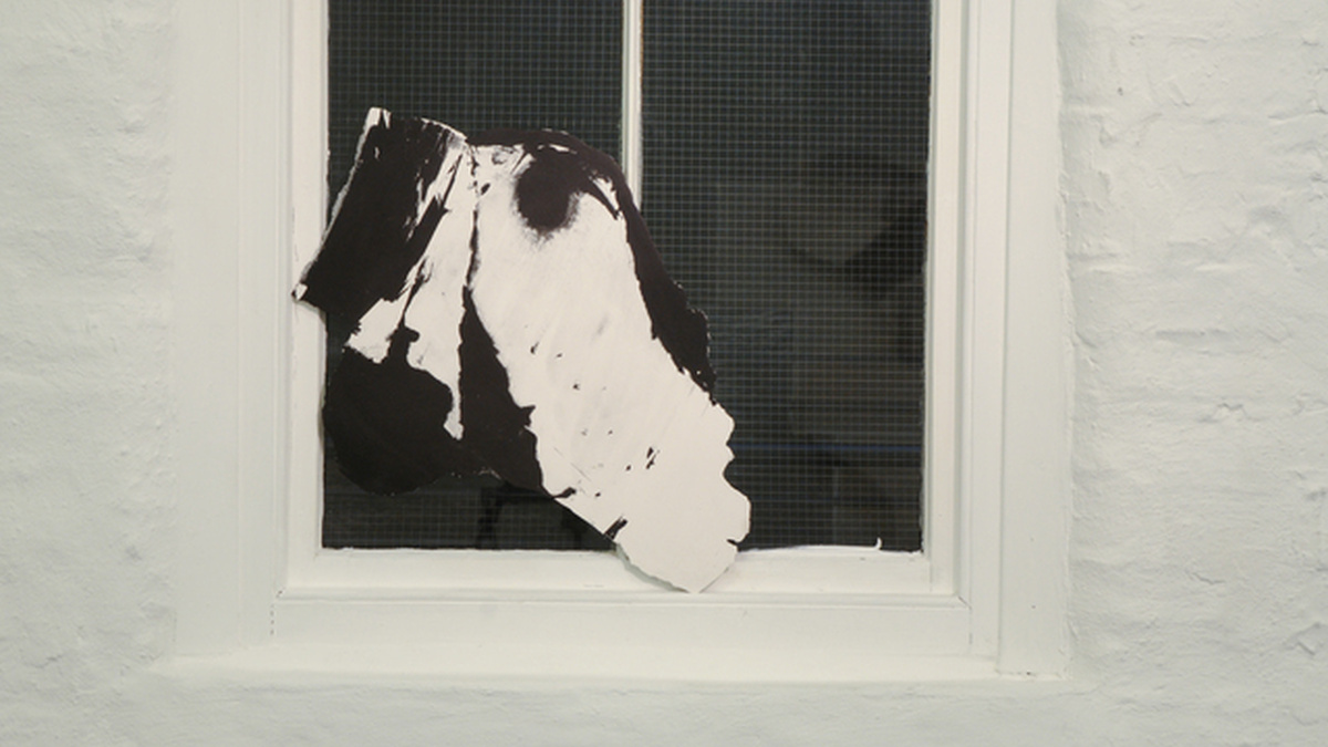 a black and white cut out in front of a window