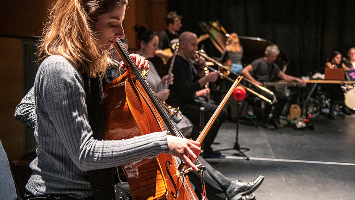 The Glasgow Improvisers Orchestra perform, featuring a close up of Jessica Argo playing the Cello.