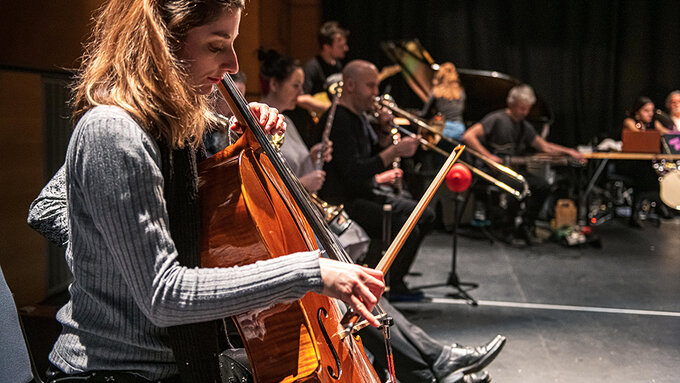 The Glasgow Improvisers Orchestra perform, featuring a close up of Jessica Argo playing the Cello.