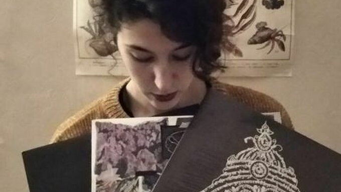 A person stands holding vinyl.