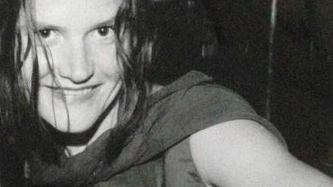 A black and white photo of Ruby McCann smiling at the camera.