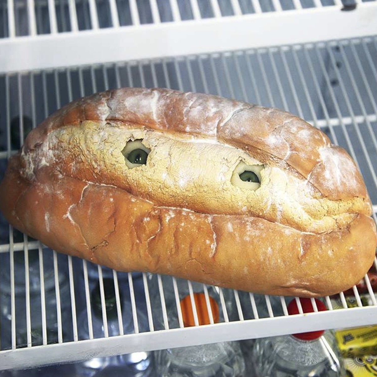 A sculpture that looks like a loaf of bread. Two beady eyes peer out from the middle.