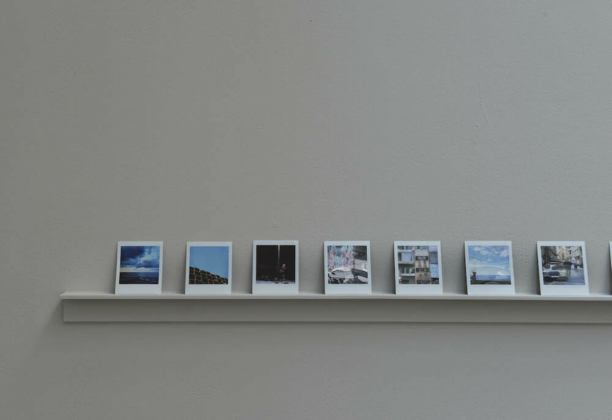 Polaroid photographs of Beirut sat on a small shelf