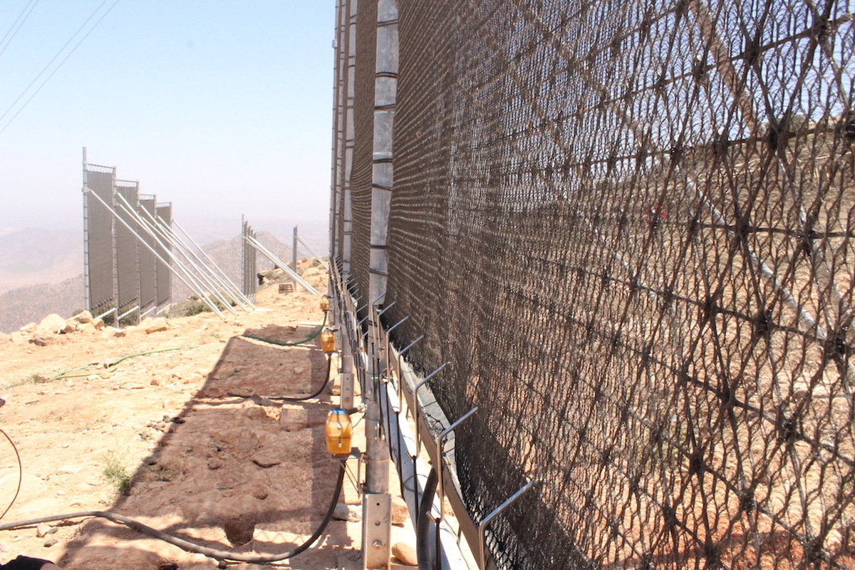 An image of a cloudfisher, a large industrial metal mesh structure it looks similar to a chainlink fence.