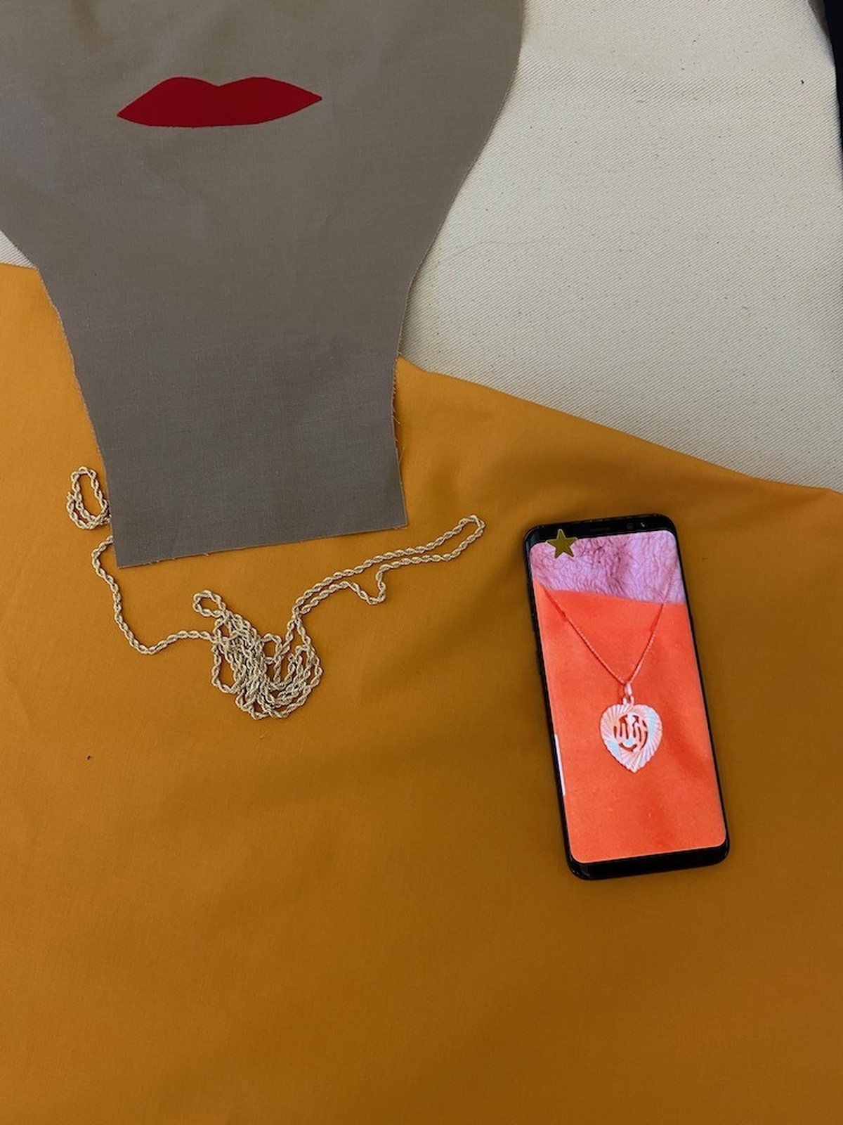 A close up of the header image with a phone with a pendant on it.