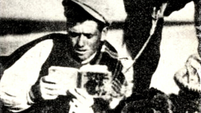 A black and white photograph of a person reading a book.