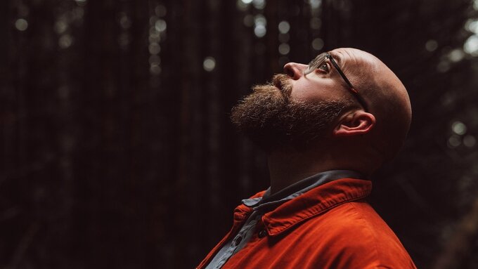 Findlay looking to the sky in with his arms spread out.