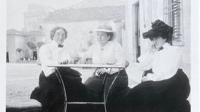 Claribel Cone, Gertrude Stein, and Etta Cone seated at a table