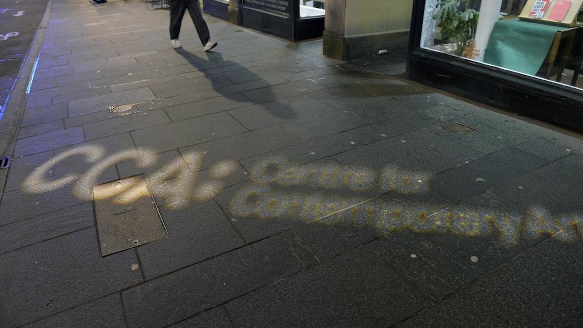 A pavement is illuminated with the CCA logo.