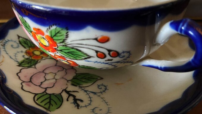 A close up photograph of a blue and white porcelain teacup.