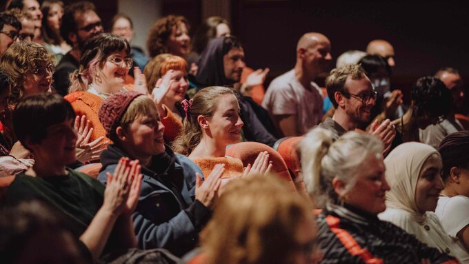 A smiling and applauding audience at Glasgow Film Theatre