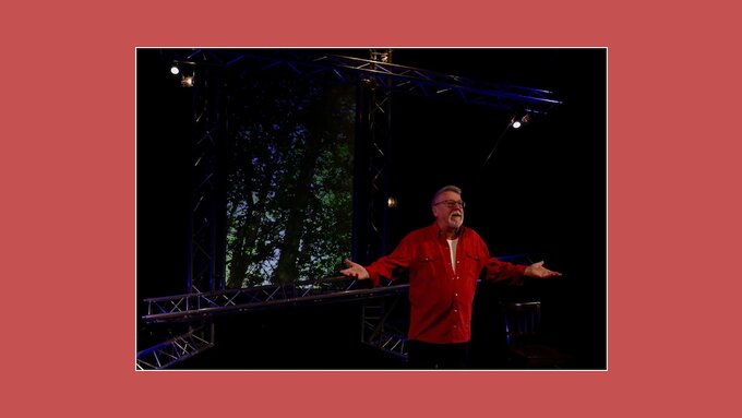 Photograph of John Bolland performing Pibroch onstage.