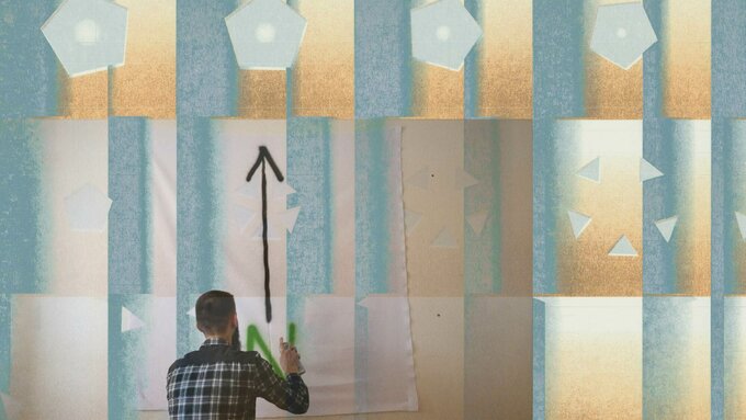 A grid of moving polygons and triangles is overlaid with a video still showing a person spraying painting.