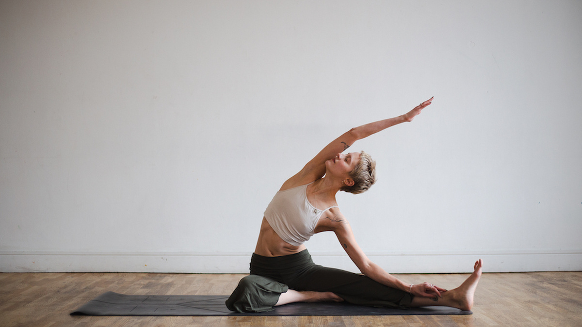 A person doing a seated side bend.