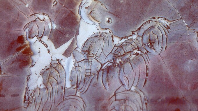 A photograph of a melted map, the surface of the map has degraded and the writing is illegible.