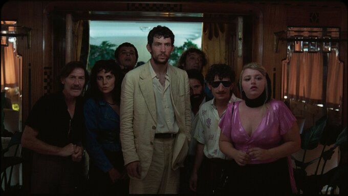 Image of Arthur (Josh O'Connor) and his gang of grave robbers on a boat