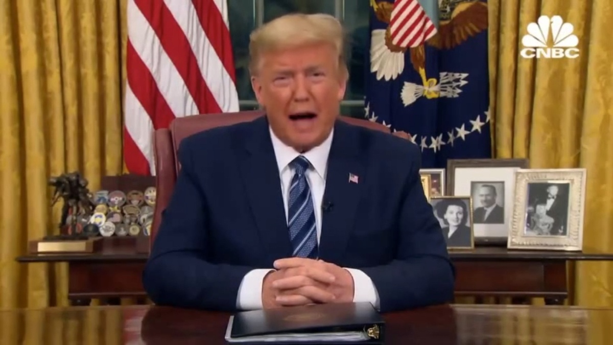 A grainy image of Donald Trump sat at the White House desk.