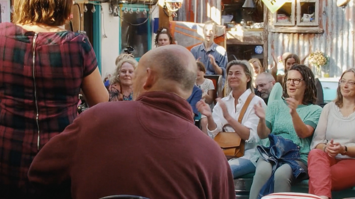 An audience of people clapping.