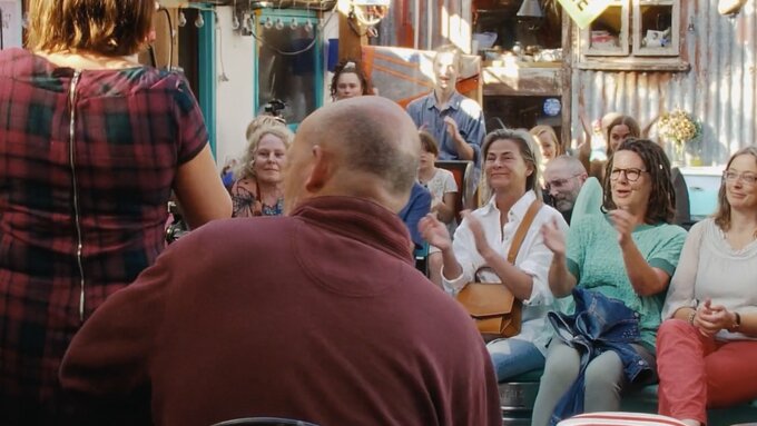An audience of people clapping.
