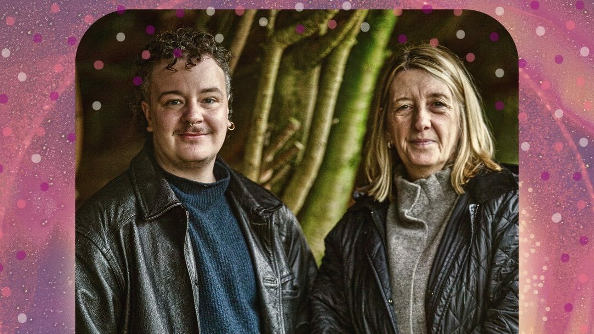 The image presents Oren and Irene standing outdoors against a backdrop of tree trunks and foliage in a natural setting.