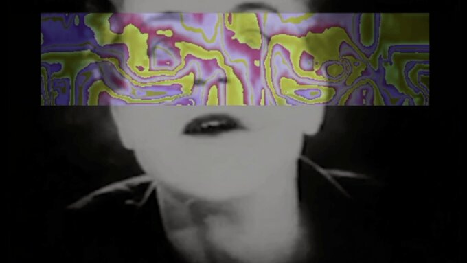 A highly processed still from Fritz Lang's Metropolis in which visual noise crosses over a woman's face.