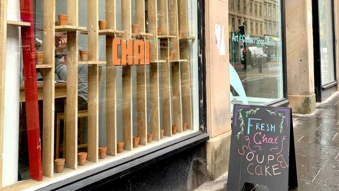 A photo of the exterior of CCA with the Slow Chai sign out front.