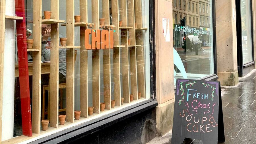 A photo of the exterior of CCA with the Slow Chai sign out front.