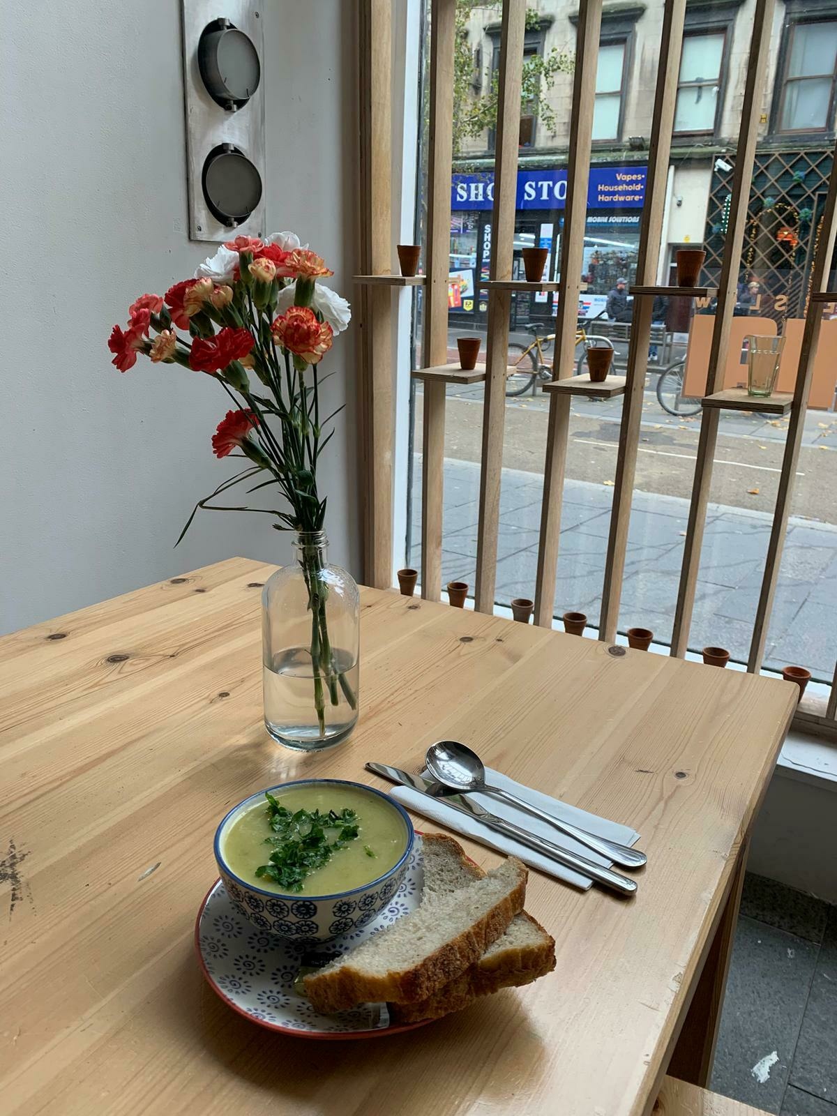 A delicious bowl of veggie soup and bread.