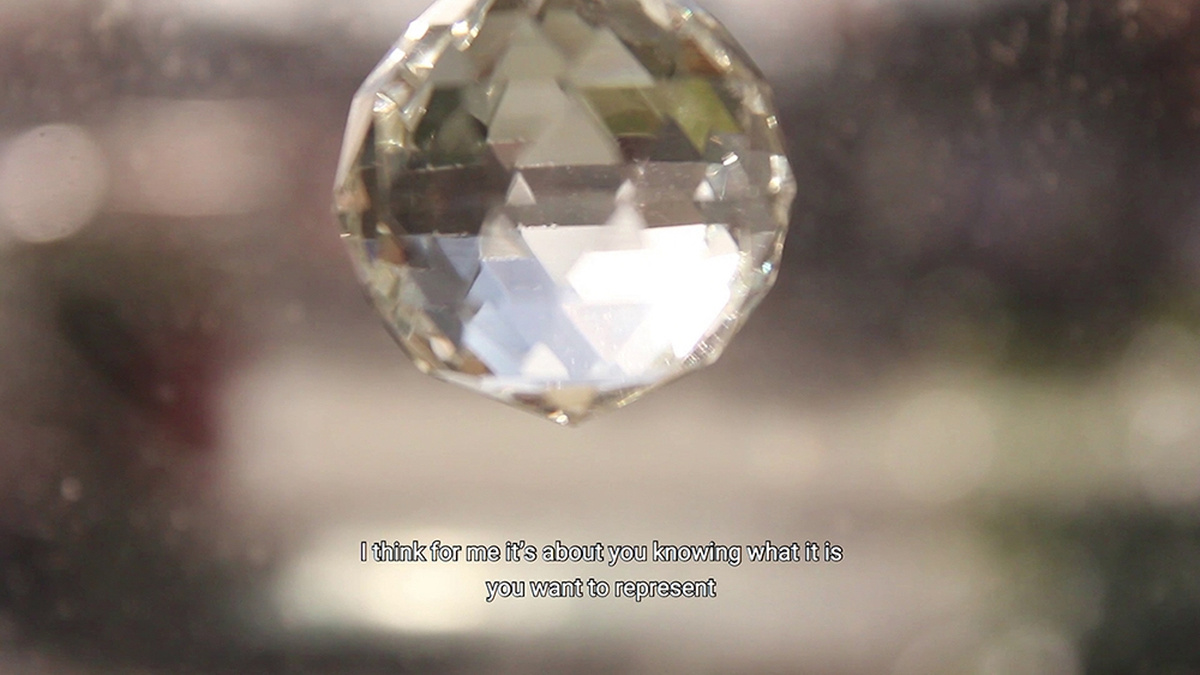A close up of a spherical gem, with an out of focus background.
