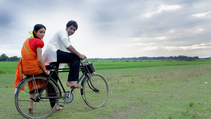 Asha & Karim cycling in the movie.