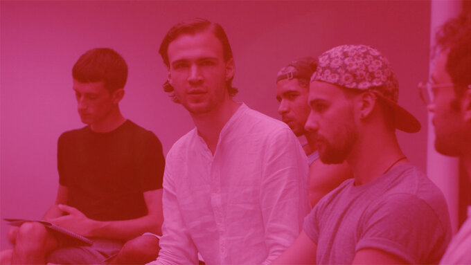A mid-shot of three young men. The whole image is a pink hue in reference to BUTT magazine.