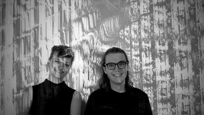 A black and white photograph of the artists Sonia Killmann and Aidan Lochrin.