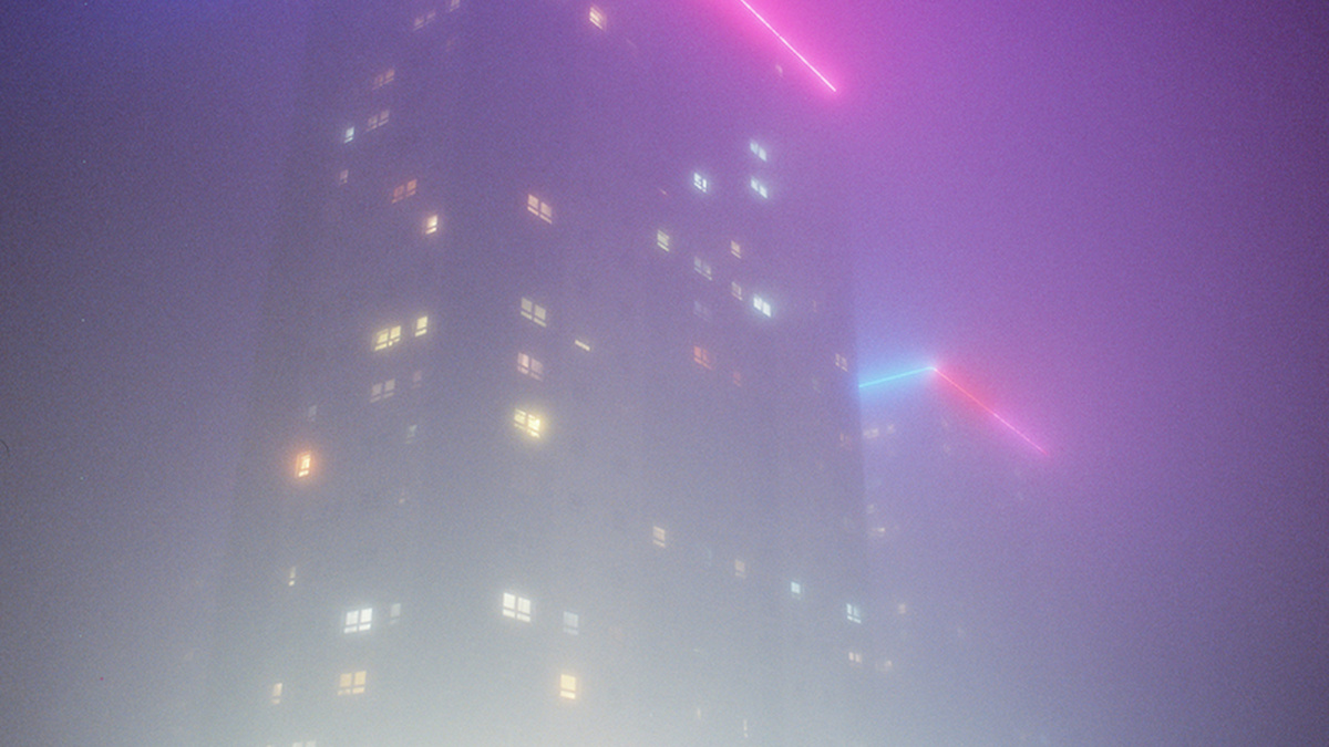 Glasgow tower block at night in the fog.